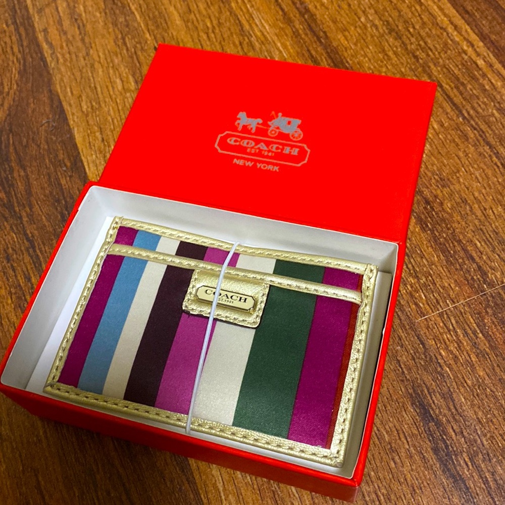 Coach wallet with multicolor stripes.